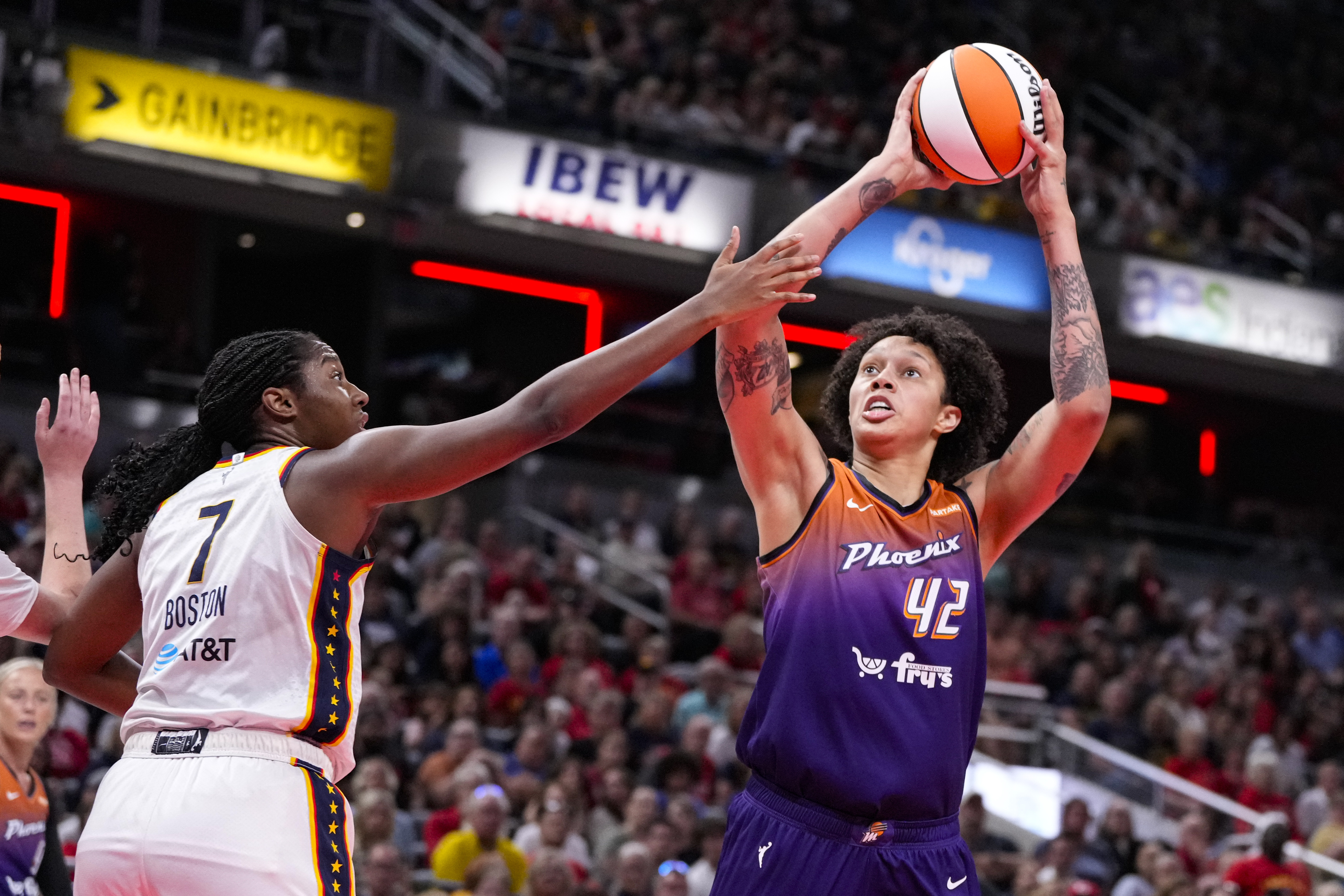 Phoenix Mercury center Brittney Griner (42) shoots over Indiana Fever forward Aliyah Boston (7) in the first half of a WNBA basketball game in Indianapolis, Friday, July 12, 2024. (AP Photo/Michael Conroy)