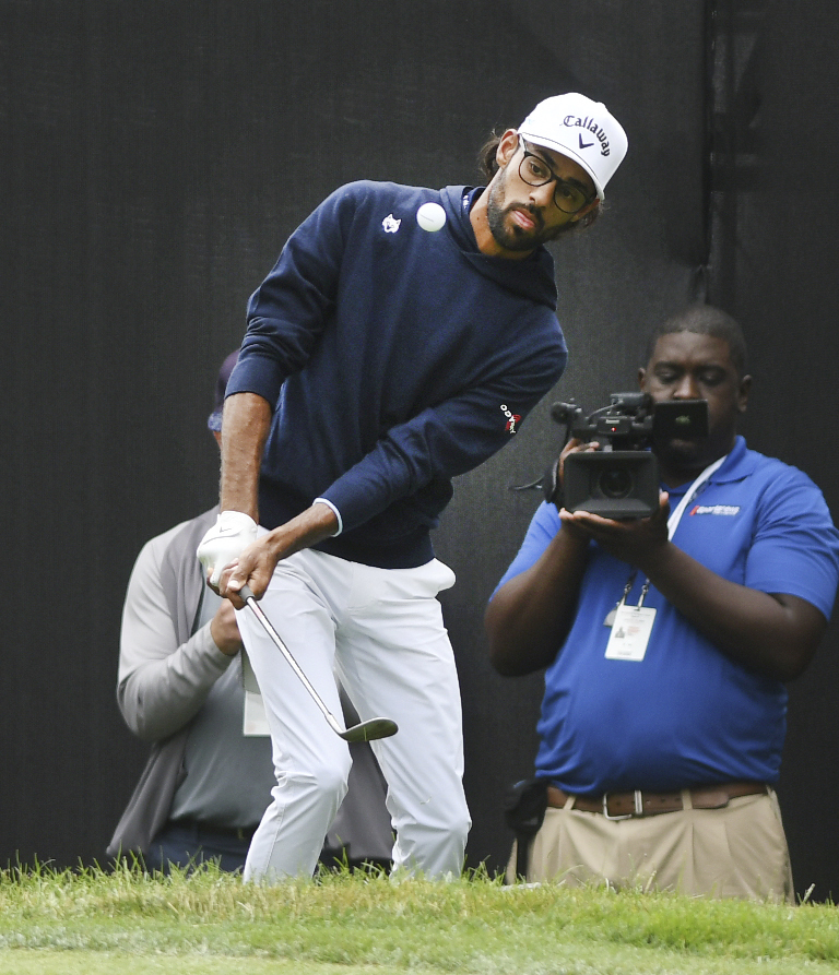 Akshay Bhatia shares the lead in Detroit after his golf ball finds a fairway drain on the 17th