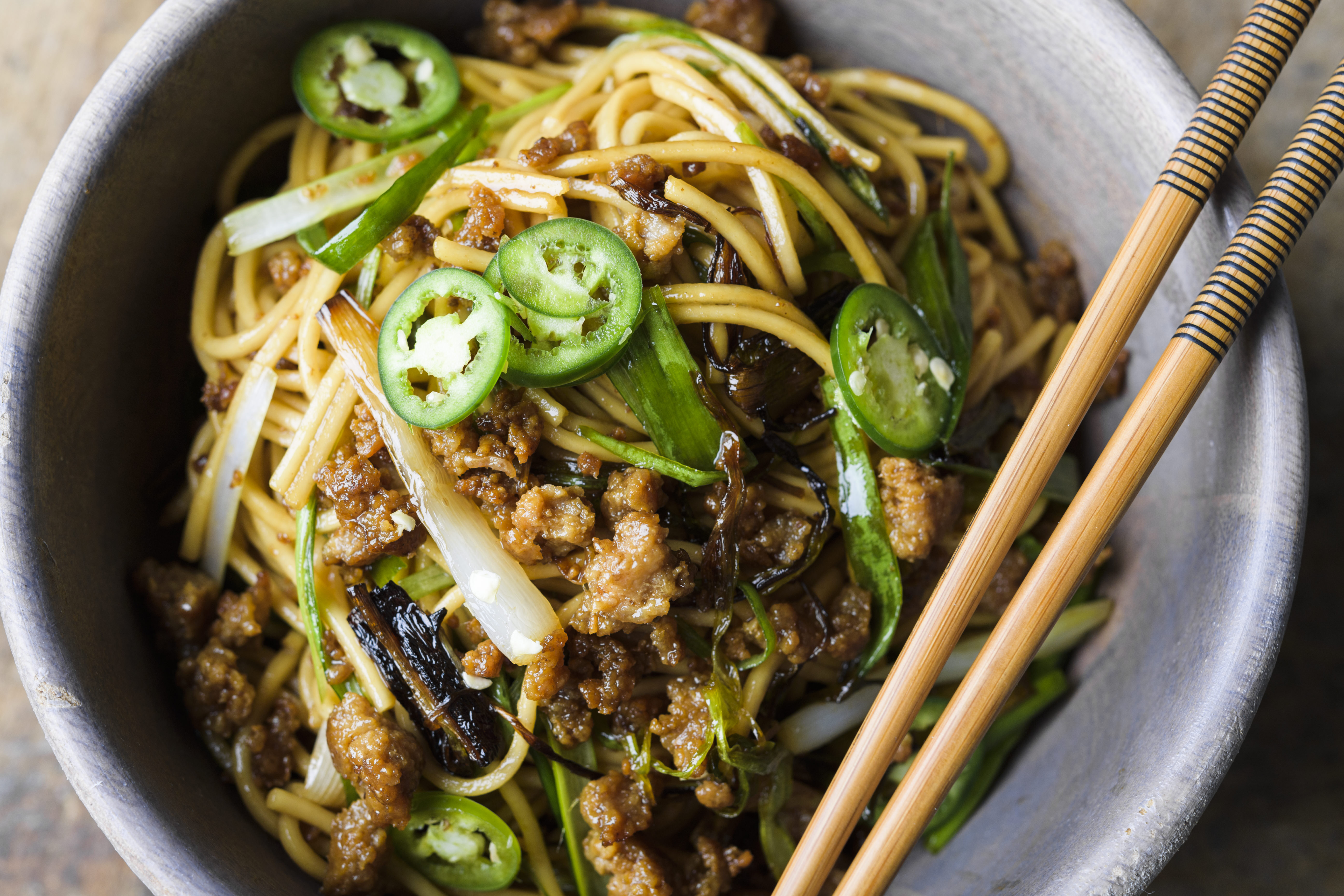 Thinly sliced fried scallions add bold flavor to savory pork noodles | AP  News