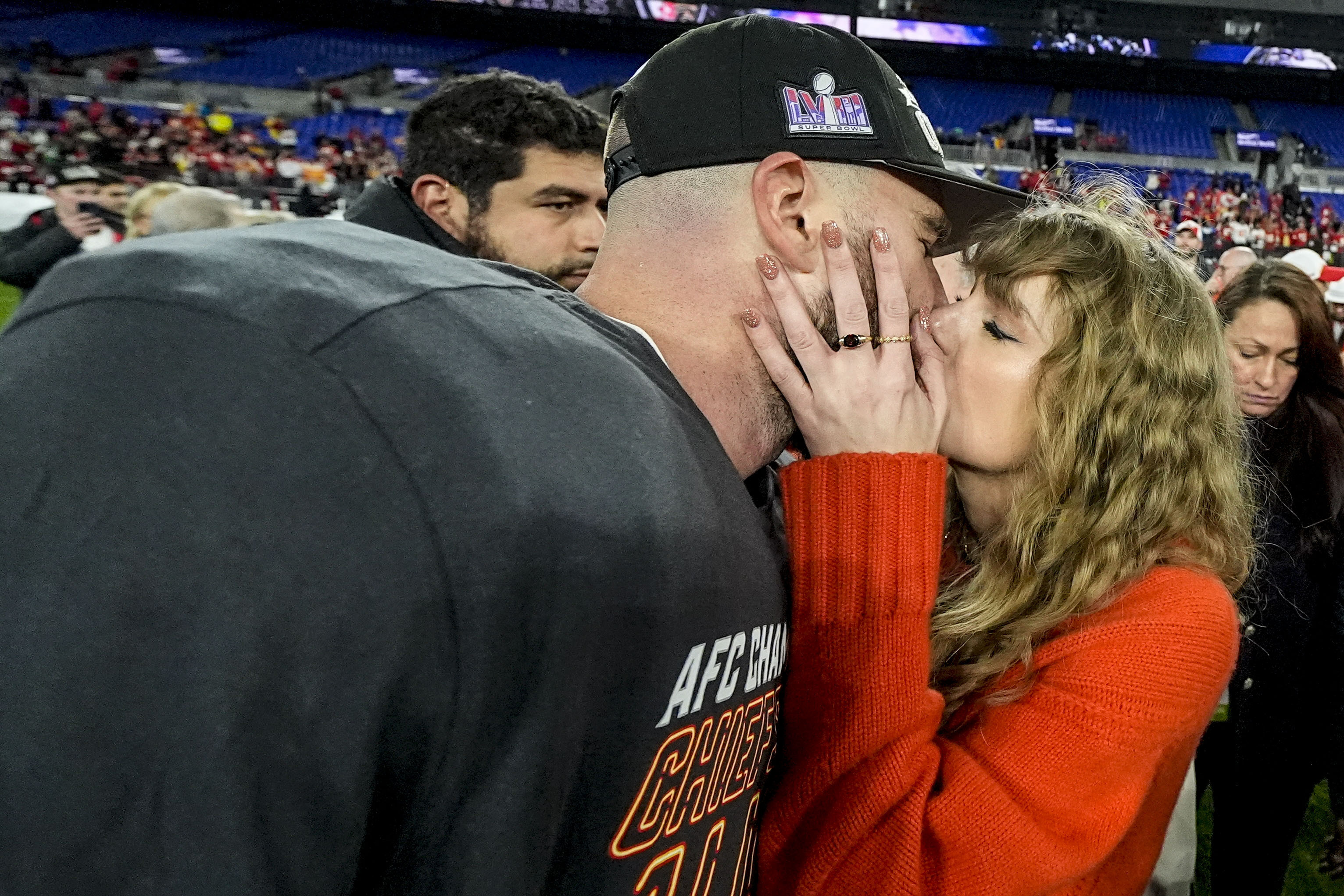 Taylor Swift greets Super Bowl-bound Travis Kelce with a kiss