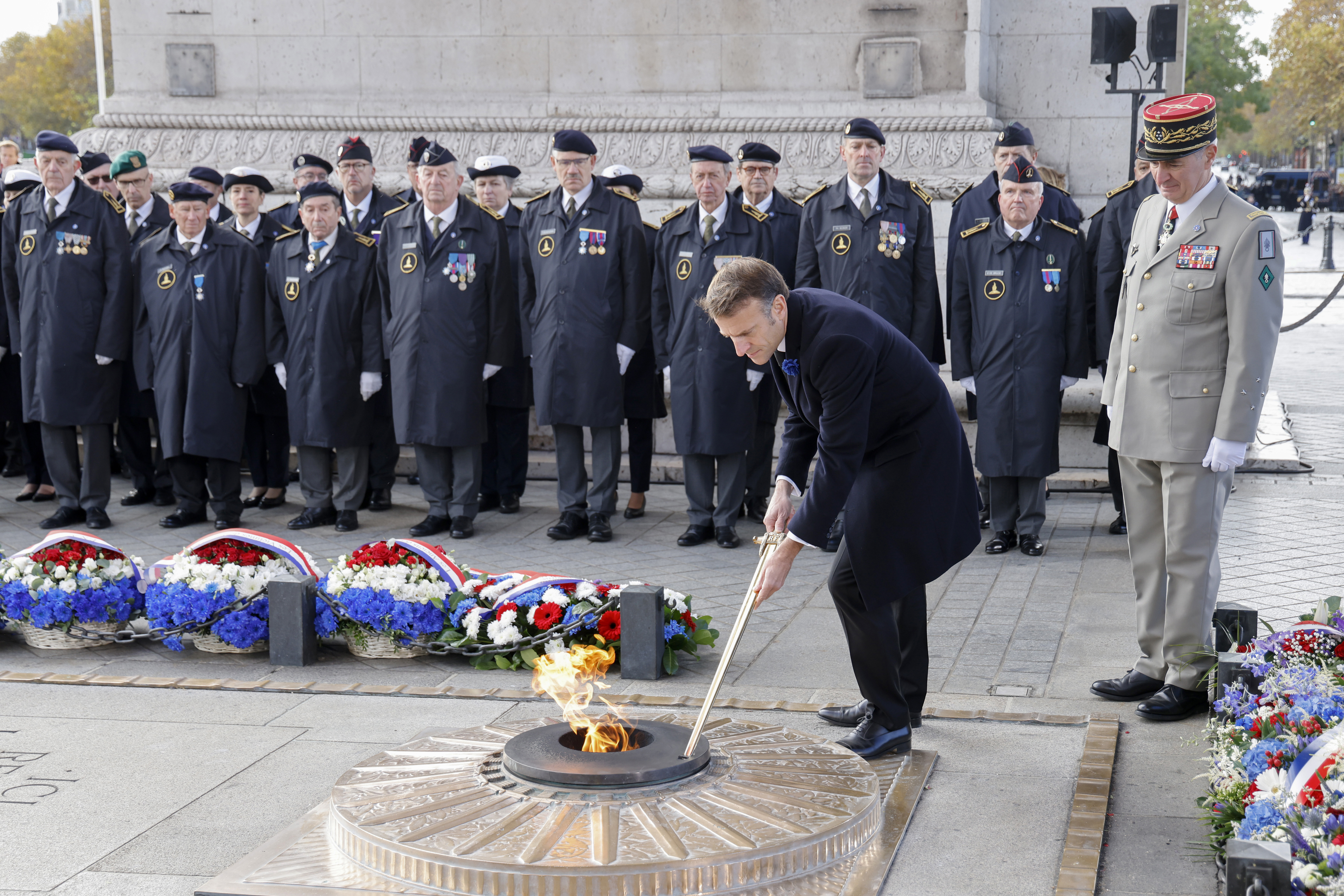 Somber bugles and bells mark Armistice Day around the globe as